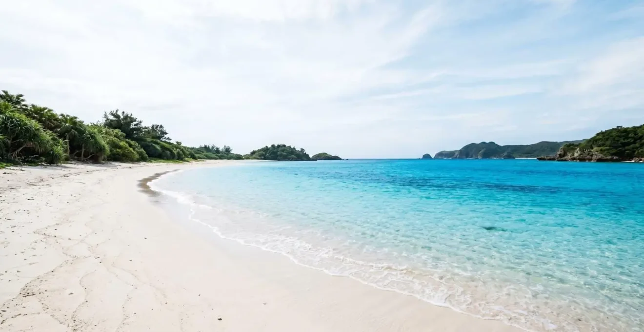 Plage paradisiaque d'Okinawa avec sable blanc et eau turquoise éclatante sous ciel bleu